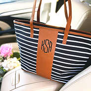 monogrammed black and striped tote bag in car