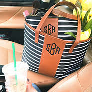 monogrammed black and white striped tote in car seat with cosmetic case