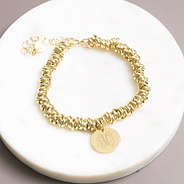 gold twisted knot bracelet on marble dish