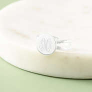 silver criss cross ring in marble dish