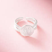 silver criss cross ring on pink background