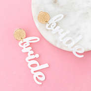 bride earrings on pink