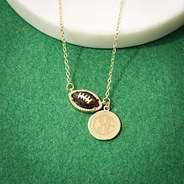 brown football necklace on green turf