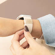 light tan monogrammed watch band on wrist