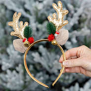 girl holding reindeer christmas headband