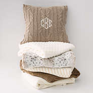 tan cable knit pillow sham on blanket stack