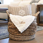 ivory textured plush blanket in basket