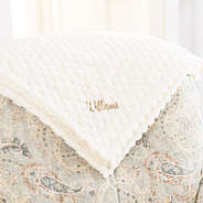ivory textured plush blanket on chair