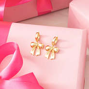 gold bow huggie hoop earrings