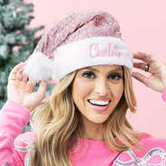 girl wearing monogrammed pink santa hat