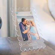 family photo in scalloped picture frame on nightstand