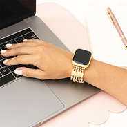 beaded pearl watch band on arm with laptop