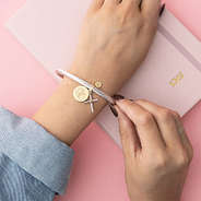 girl wearing cable cross bracelet