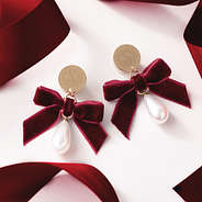 Monogrammed velvet bow earrings with red ribbons