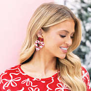 girl wearing candy cane heart earrings