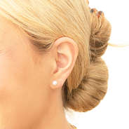 pearl earring set in ear