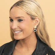 girl wearing monogrammed gold elevated dangle earrings