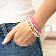 pink beaded bracelet set on arm