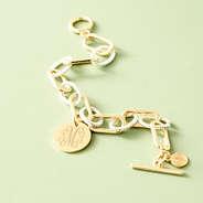 mixed metal chainlink bracelet on green background