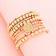 Colorful bracelet stack on pink