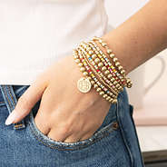 girl wearing colorful bracelet stack