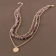 monogrammed triple layer necklace on brown background