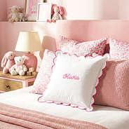pink scalloped pillow sham on girls bed