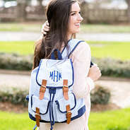 girl wearing monogrammed blue seersucker bookbag