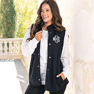 girl wearing black monogrammed sweatshirt vest