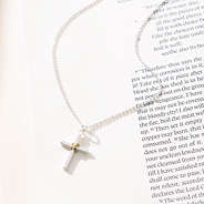 cable cross necklace on paper