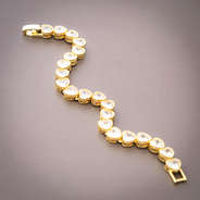 gold rhinestone heart bracelet on brown background