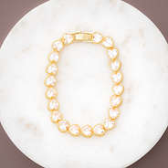 gold rhinestone heart bracelet on marble dish