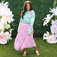 girl wearing monogrammed easter sweatshirt with plaid skirt