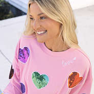 close up of girl wearing sequin hearts sweatshirt