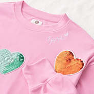 close up of pink sequin hearts sweatshirt