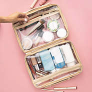 inside of monogrammed large clear toiletry case in gold