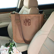 whipstitch monogrammed purse in car