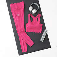 hot pink scalloped sports bra flatlay on yoga mat