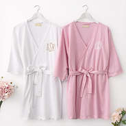 pink and white scalloped robes with flowers