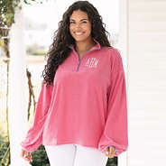 girl wearing monogrammed puff sleeve fleece pullover in pink up close