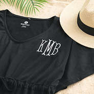 close up of monogrammed cinch waist cover up in black