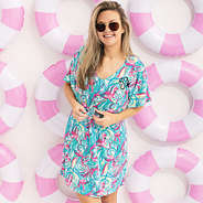 girl wearing monogrammed cinch waist cover up in blue and pink flamingo splish splash