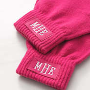 close up of monogrammed hot pink gloves