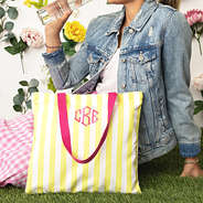 yellow and pink striped tote while girl drinks