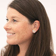 crystal bow earrings in ears