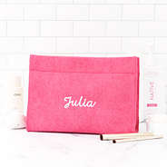 hot pink terry toiletry bag on bathroom counter
