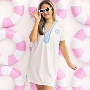 girl wearing personalized seersucker cover up with pink beach background