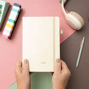 light tan notebook in hands