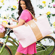 pink seersucker weekender on shoulder