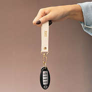 ivory classic keychain held up by bella